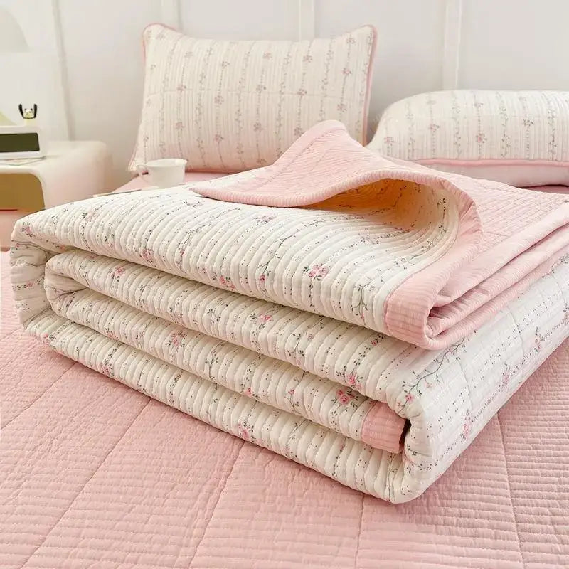 A soft folded floral quilt with pink piping on off-white decorbites cartoon small fresh bed sheets