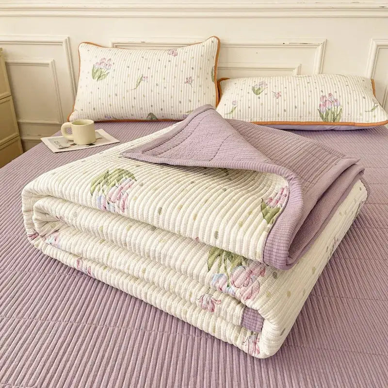 A soft lavender and cream floral quilt with ribbed texture and folded edges in decorbites cartoon small fresh bed sheets