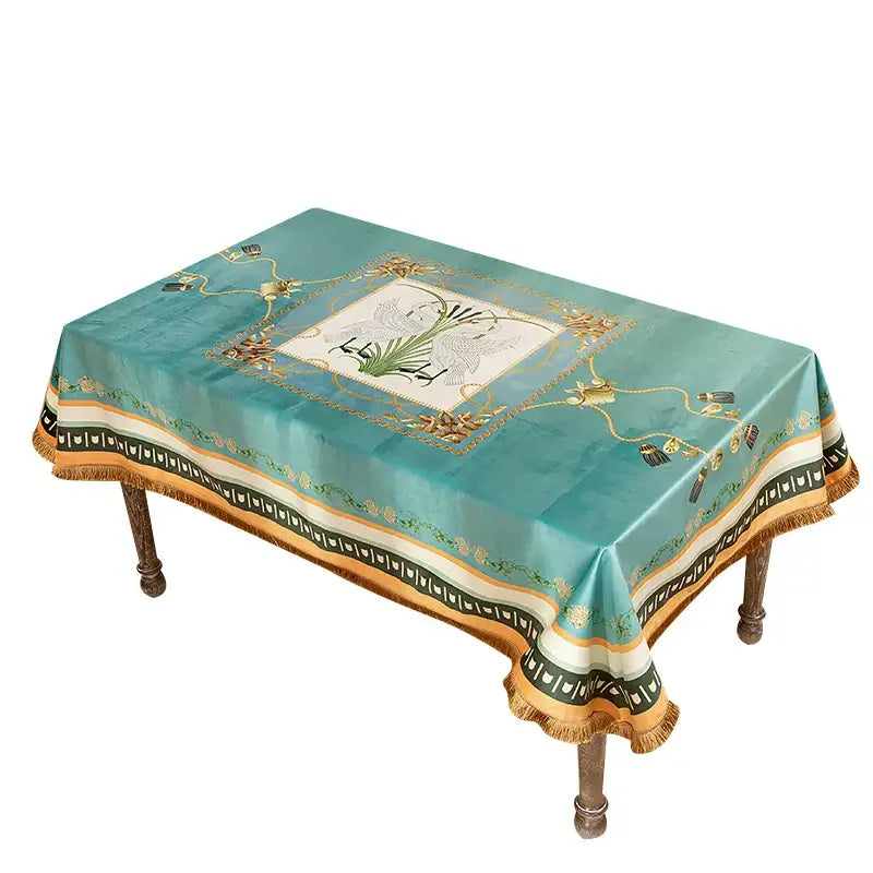 Elegant teal floral print velvet tablecloth with gold bird embroidery and tassels for sophisticated dining room decor