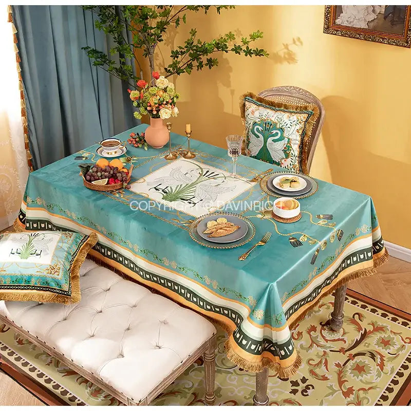 Teal floral print velvet tablecloth with gold and green embroidered borders fringed edges and central botanical design