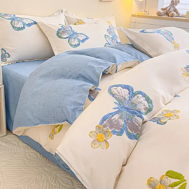 Cream-colored decorbites cotton printed bedding set with embroidered blue butterflies and yellow flowers on duvet cover