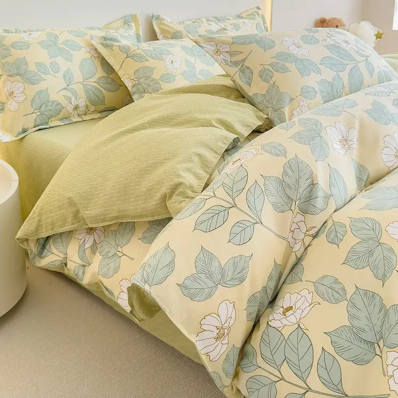 A soft yellow cotton printed bedding set with floral puppy design featuring white blossoms and sage green leaves