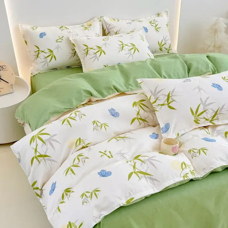 White duvet cover and pillowcases with green bamboo leaves and blue butterflies on light green decorbites cotton printed bedding set