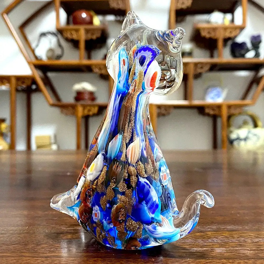 A translucent blue and gold cat glass figurine with swirling patterns and floral details for cute cat decor