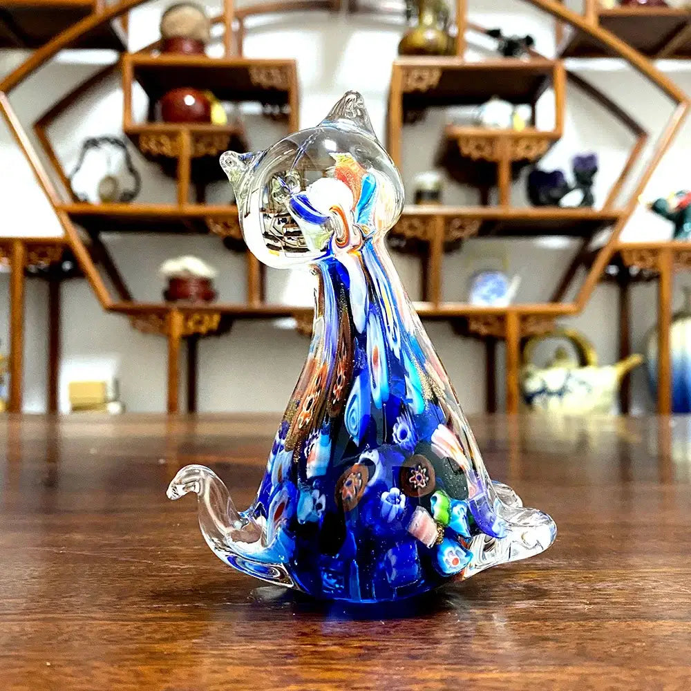 A translucent blue and clear glass cat glass figurine with intricate colorful patterns for cute cat decor