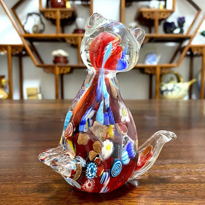 A vibrant translucent glass cat figurine with red blue and gold floral patterns for cute cat glass decor