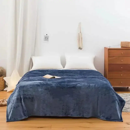 Deep blue plush throw blanket with soft velvety texture made of coral fleece flannel for decorbites bedroom decor