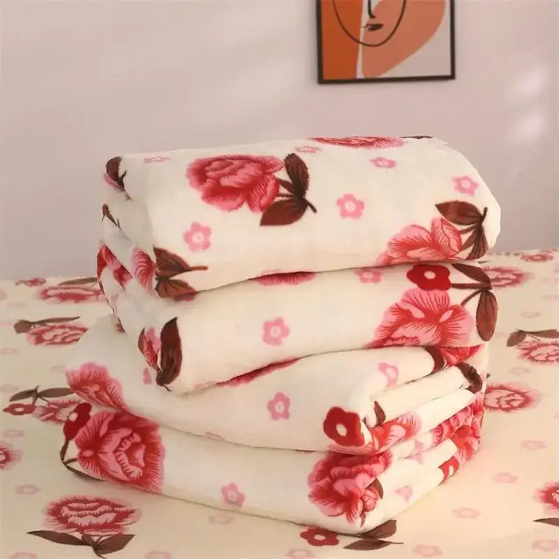 Stack of plush white coral fleece flannel blankets with vibrant red and pink floral patterns for bedroom decorbites coral fleece