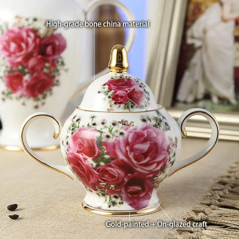 A delicate white bone china sugar bowl with vibrant pink roses and gold accents from decorbites tea set