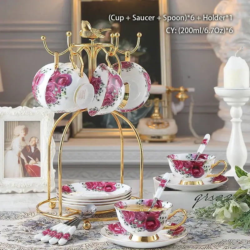 White porcelain bone china tea set with vibrant pink rose patterns and gold trim on golden decorbites cup rack