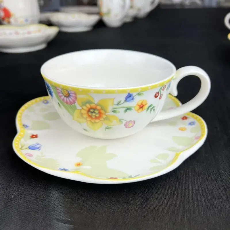 Delicate white porcelain teacup and saucer with vibrant floral pattern in a tulip dinnerware set for dining room use