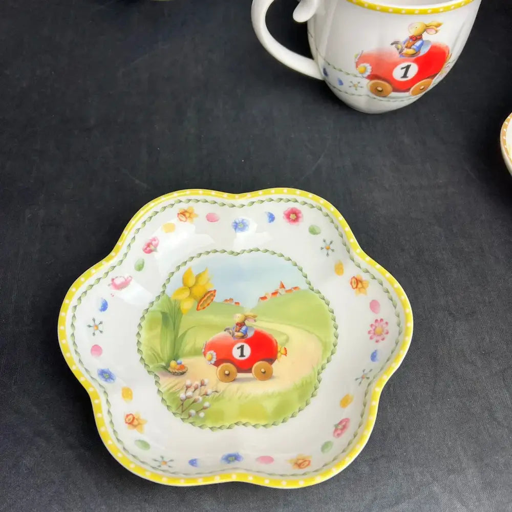 White ceramic scalloped dish with yellow trim and red race car illustration in floral scalloped tulip dinnerware set