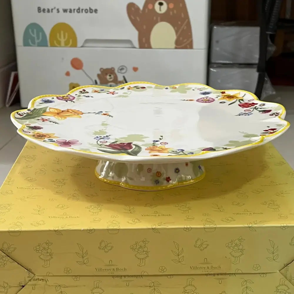 White ceramic cake stand with scalloped edge and floral patterns from tulip dinnerware set for dining room use