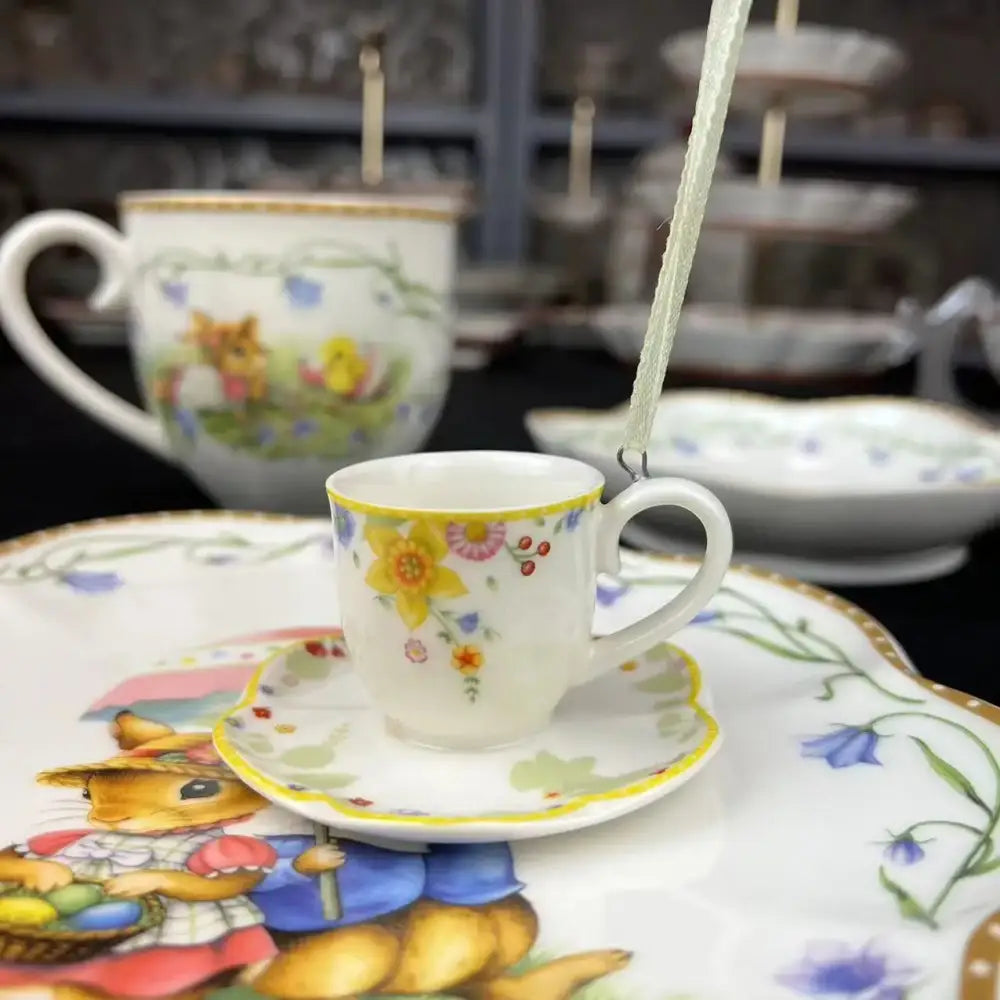 A delicate white porcelain espresso cup with yellow rim and floral design from easter tulip dinnerware set