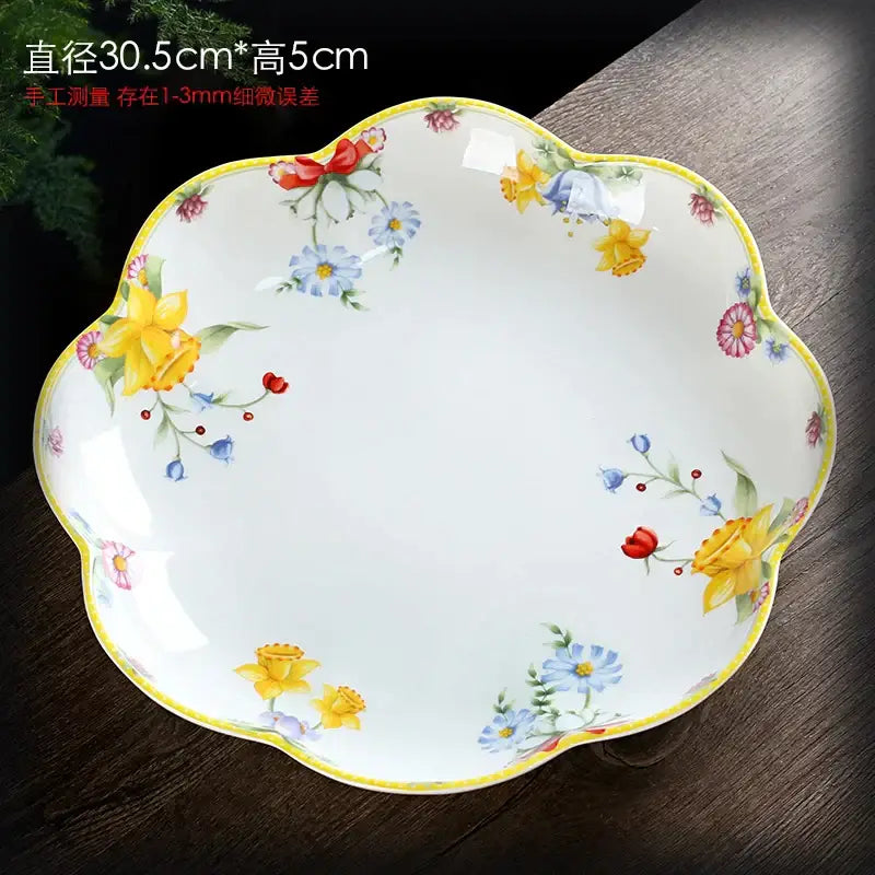 White ceramic scalloped serving dish with hand-painted yellow blue red flowers in floral tulip dinnerware set