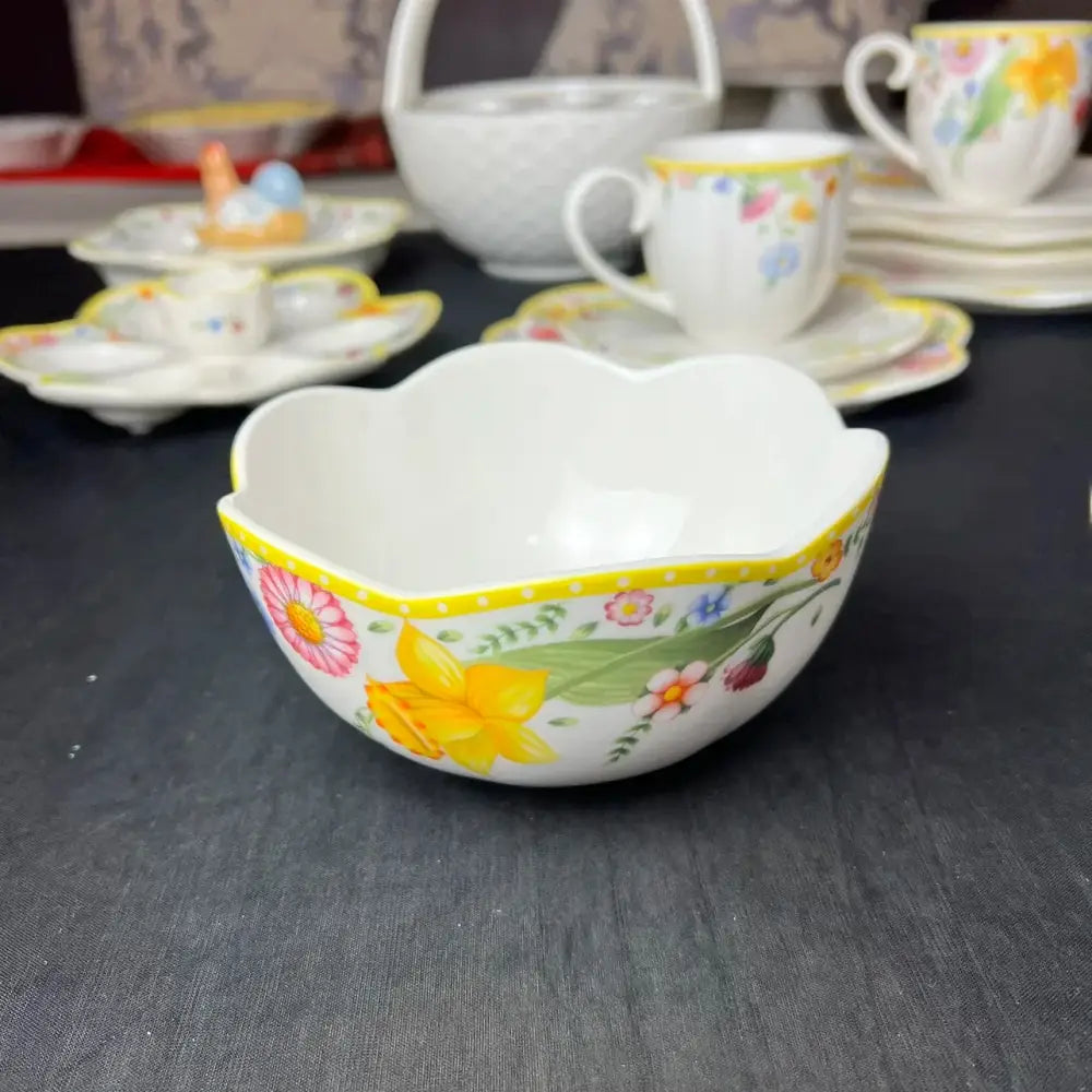 White porcelain dinnerware set bowl with scalloped rim and vibrant floral patterns in yellow easter tulip dinnerware design