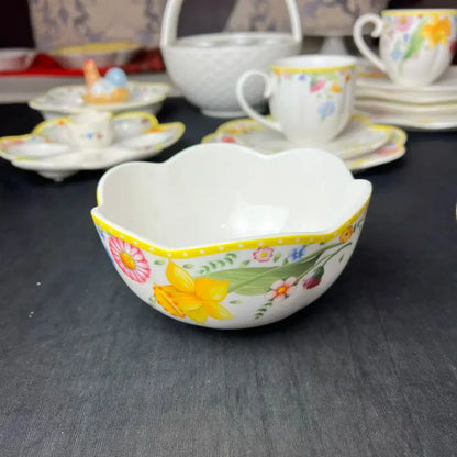 White porcelain dinnerware set bowl with scalloped rim and vibrant floral patterns in yellow easter tulip dinnerware design