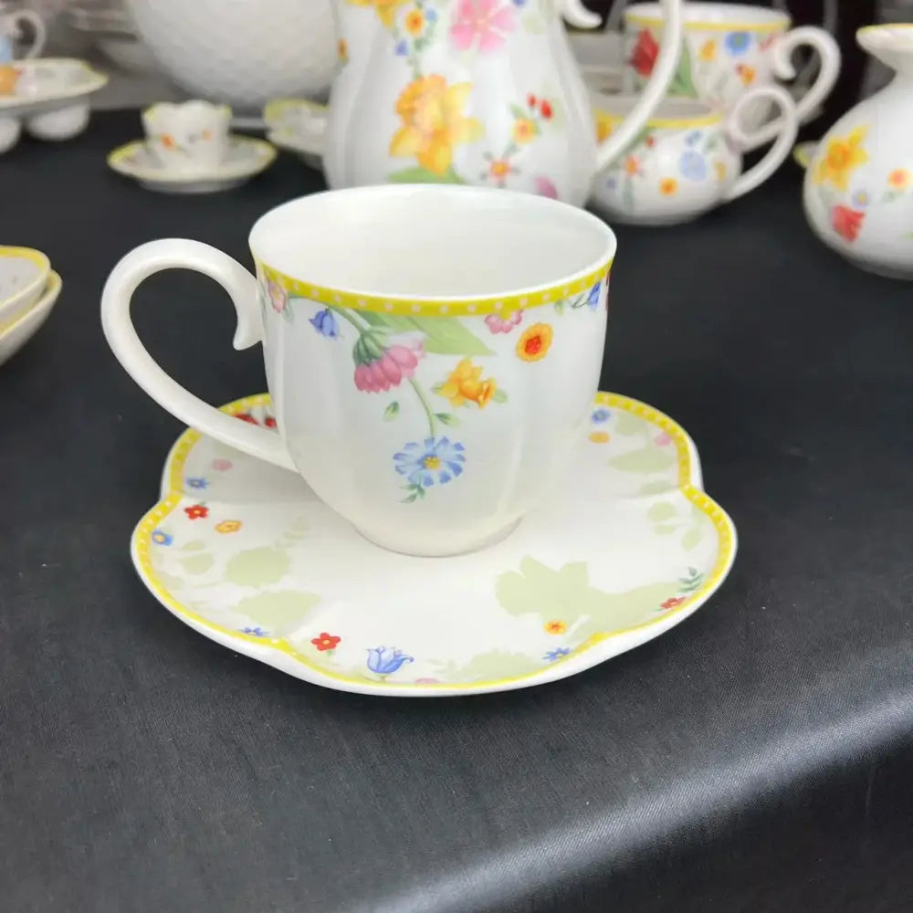 A delicate white porcelain tulip dinnerware set with a floral pattern in soft pastel hues for elegant dining