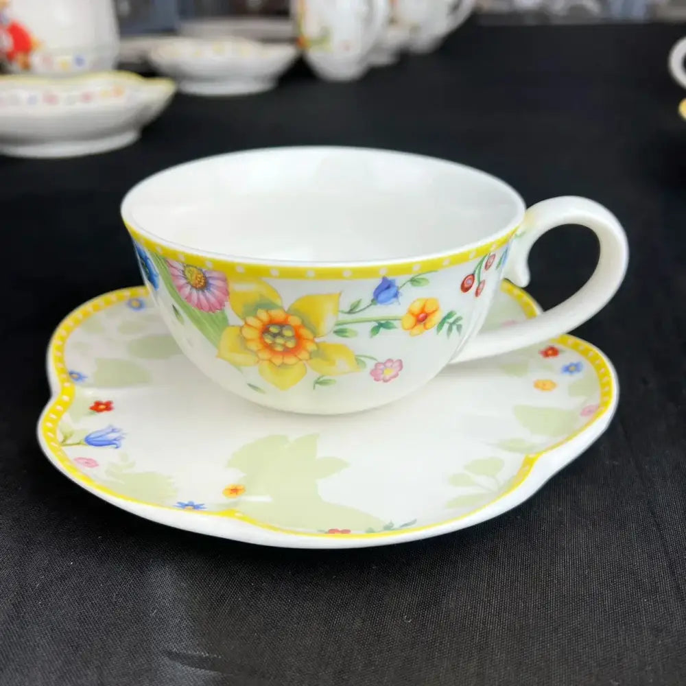Delicate white porcelain floral scalloped tulip dinnerware set with yellow daffodils and blue forget-me-nots border