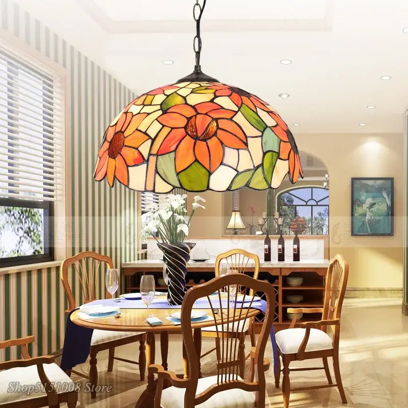 Vibrant floral stained glass baroque tiffany pendant light in orange yellow green and cream hues for dining room decor