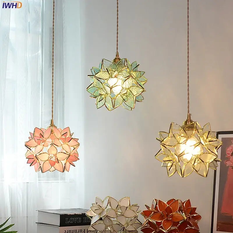 Three floral stained glass copper led pendant lamps in green pink and amber with gold-toned frames for dining room lighting