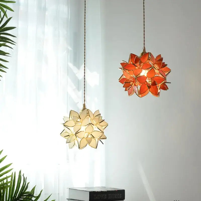 Two floral stained glass copper led pendant lamps with orange and cream petals for dining room lighting