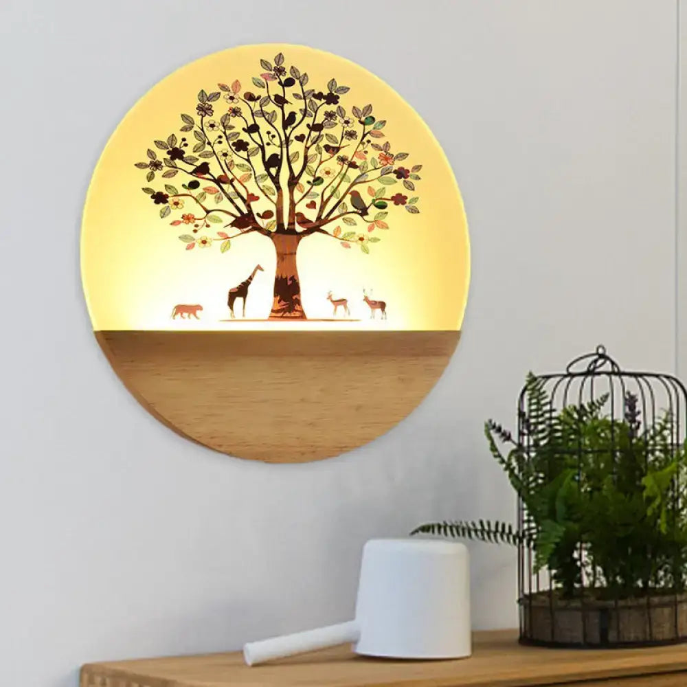 Circular wall light with acrylic shade featuring a brown and green flowering tree design and warm yellow glow for bedroom use