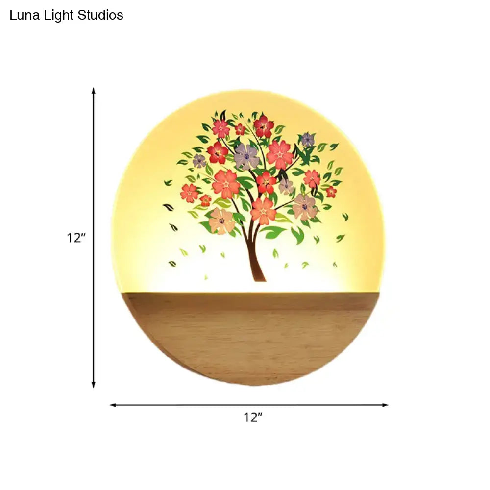 Circular wooden wall light with glowing yellow acrylic shade featuring colorful floral tree design for bedroom use