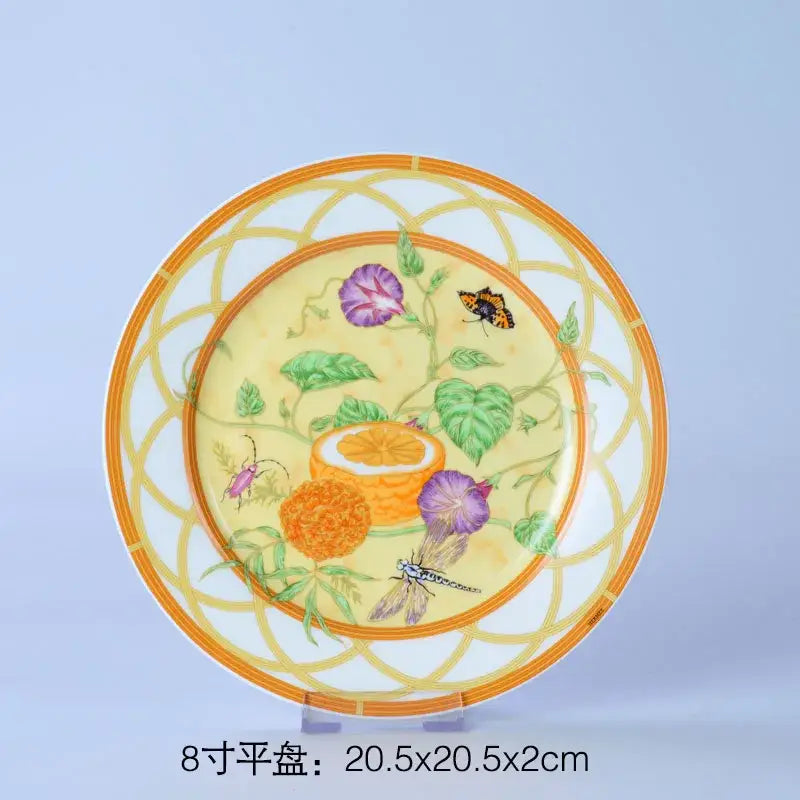 A decorative ceramic plate with vibrant yellow and floral illustrations from a floral turquoise and gold bone dinnerware set