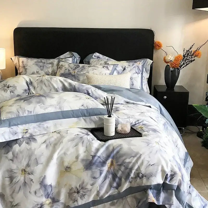 A luxurious egyptian cotton bedding set with blue and white watercolor floral pattern and gray piping accents