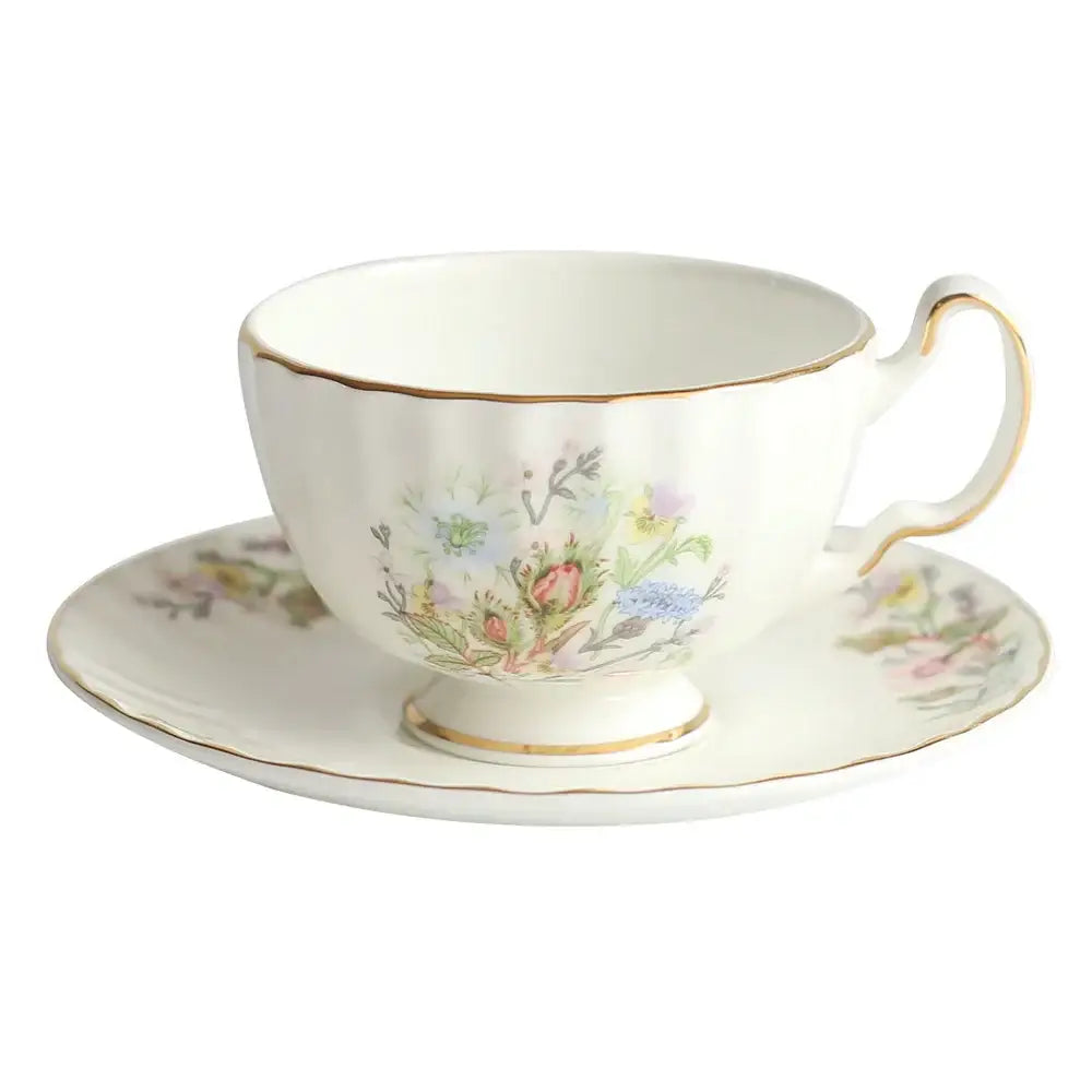 A delicate white porcelain tea cup set with gold rim and floral design made of bone china for dining room use