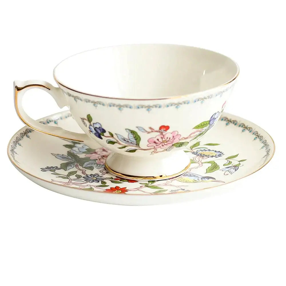 Delicate white bone china tea cup set with vibrant floral pattern and gold rim for elegant dining room drinkware
