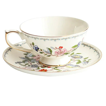 Delicate white bone china tea cup set with vibrant floral pattern and gold rim for elegant dining room drinkware