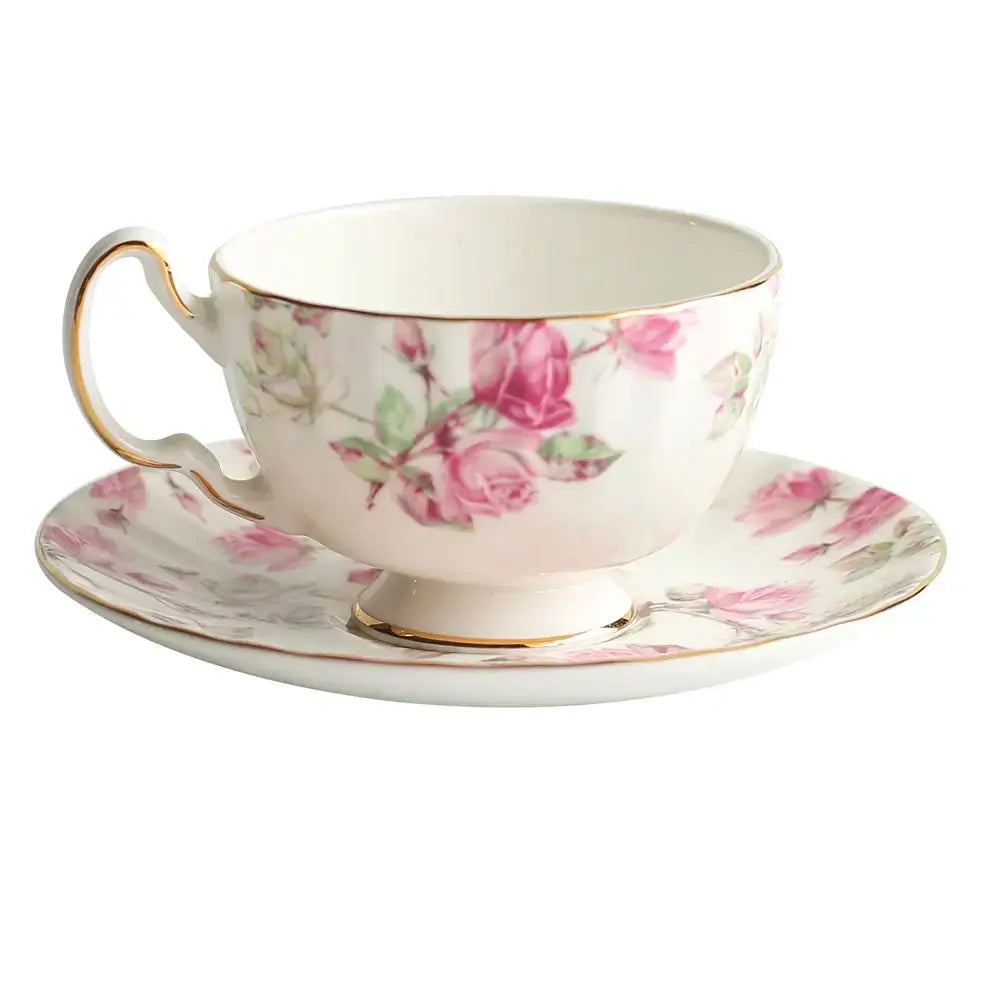 Delicate white bone china tea cup set with soft pink rose pattern and gold rim for elegant dining room use
