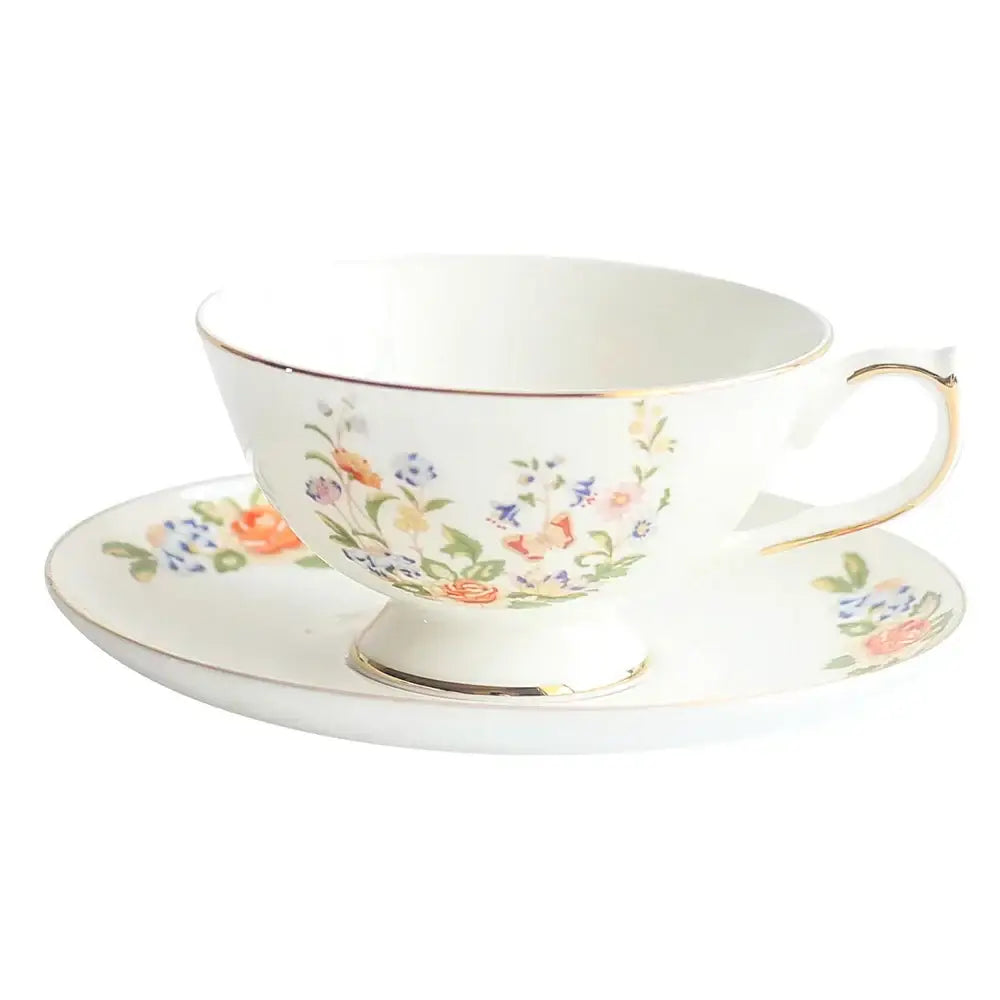 A delicate white bone china tea cup set with floral pastel pattern and gold rim perfect for elegant dining