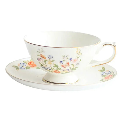 A delicate white bone china tea cup set with floral pastel pattern and gold rim perfect for elegant dining