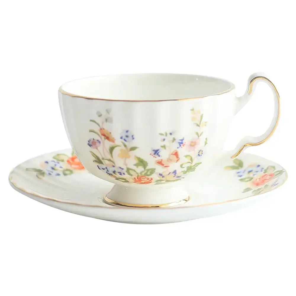 A delicate white bone china tea cup set with pastel floral pattern and gold rim perfect for elegant drinkware