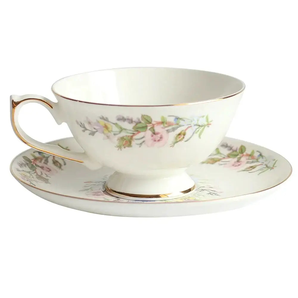 Delicate white bone china tea cup set with soft pink floral patterns and gold rim for elegant dining room drinkware