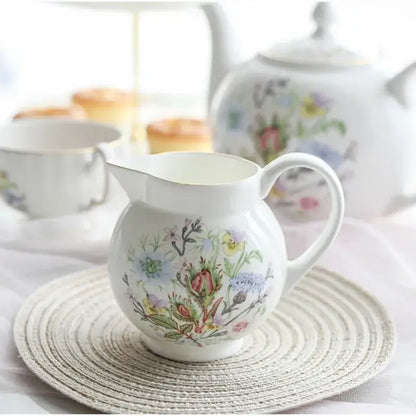 White ceramic pitcher with delicate pastel floral patterns in bone tea set for an elegant tea-drinking experience