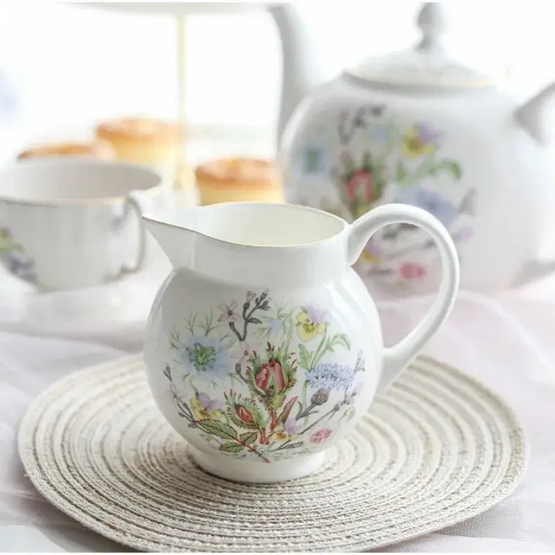 White ceramic pitcher with delicate pastel floral patterns in bone tea set for an elegant tea-drinking experience