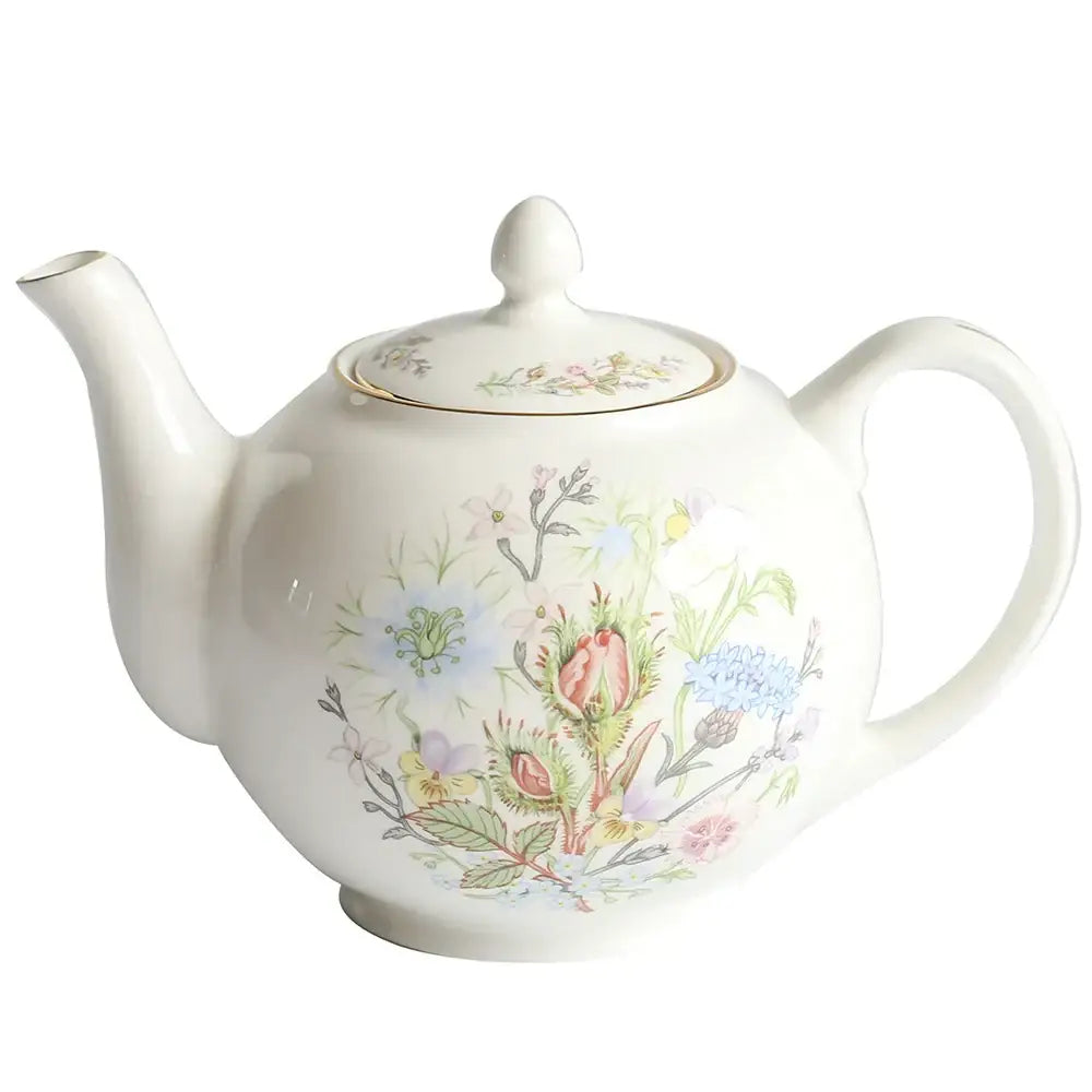 A delicate white bone china tea set teapot with pastel floral pattern and gold rim enhances tea drinking experience