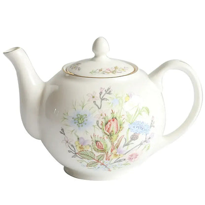 A delicate white bone china tea set teapot with pastel floral pattern and gold rim enhances tea drinking experience