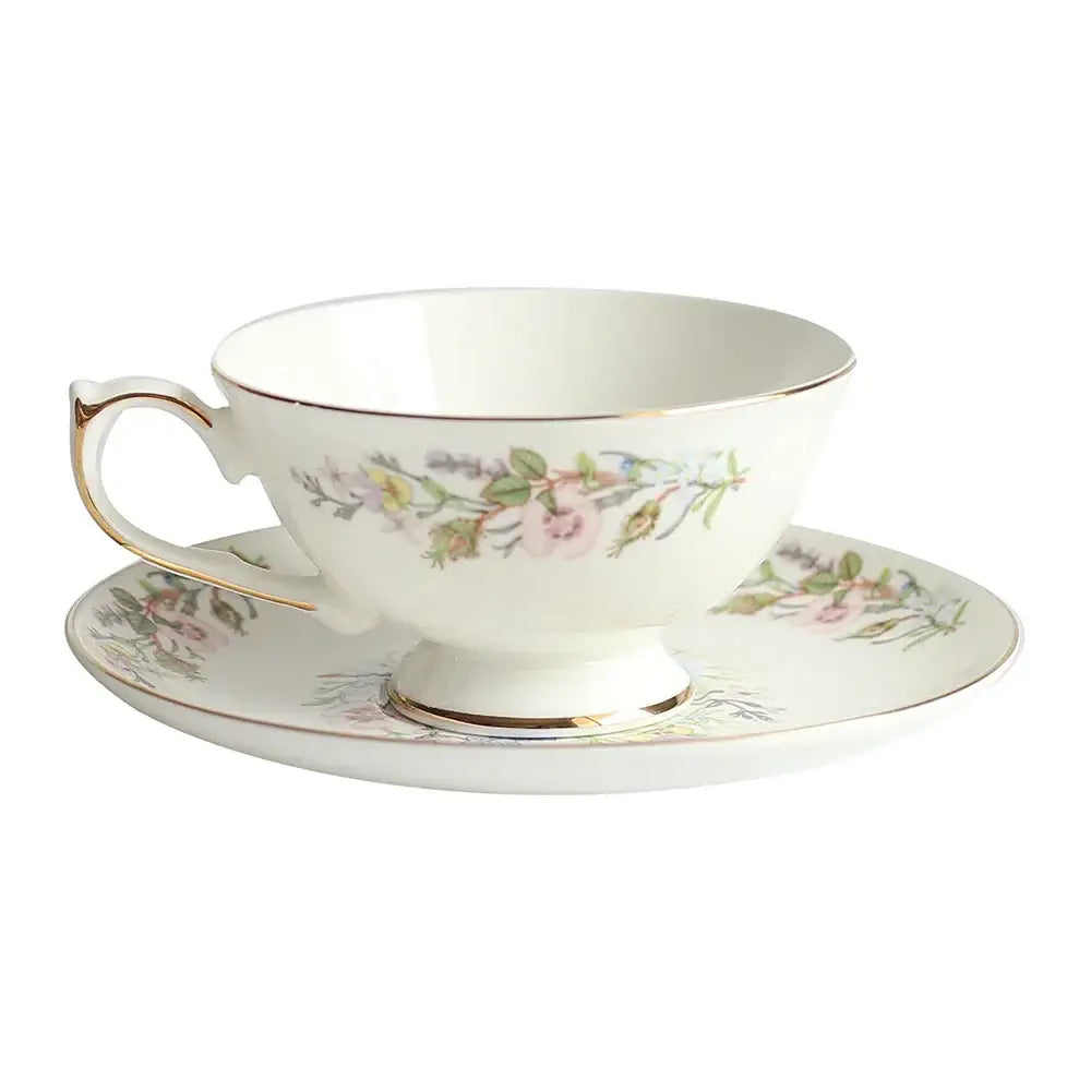 A delicate white bone china tea set teacup with gold rim and pink floral patterns enhances tea drinking experience