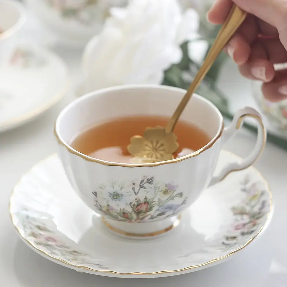 A delicate white bone tea set porcelain teacup with gold trim and floral pattern enhancing the tea-drinking experience