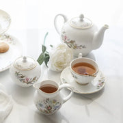 White bone tea set with delicate floral patterns and gold trim enhancing the tea-drinking experience