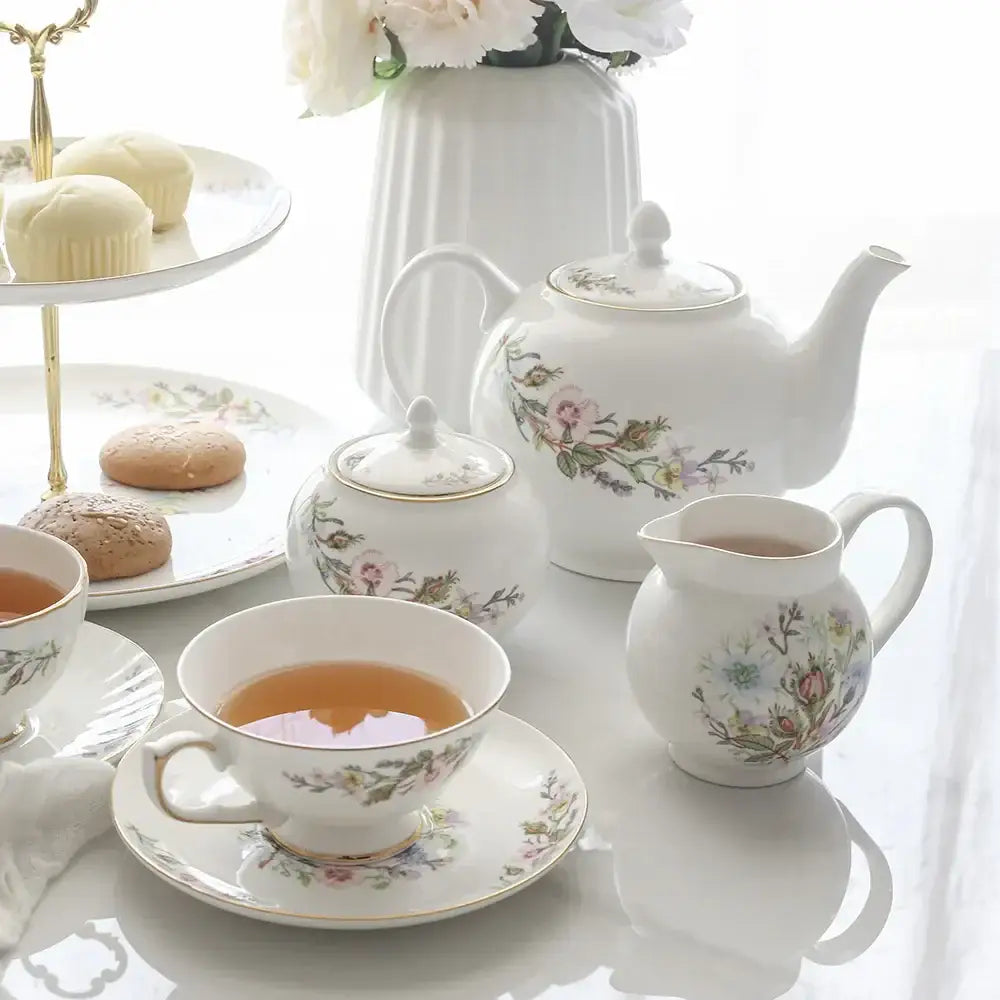White porcelain teapot with delicate floral patterns and gold-trimmed lid from bone tea set for tea-drinking experience
