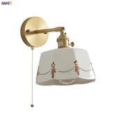 White ceramic brass led wall light with gold arm, pull chain, and red black floral scalloped edge for bedroom use