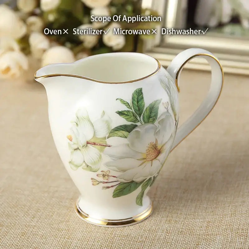 White porcelain creamer with gold-trimmed edges and delicate white green floral design from decorbites camellia bone china set