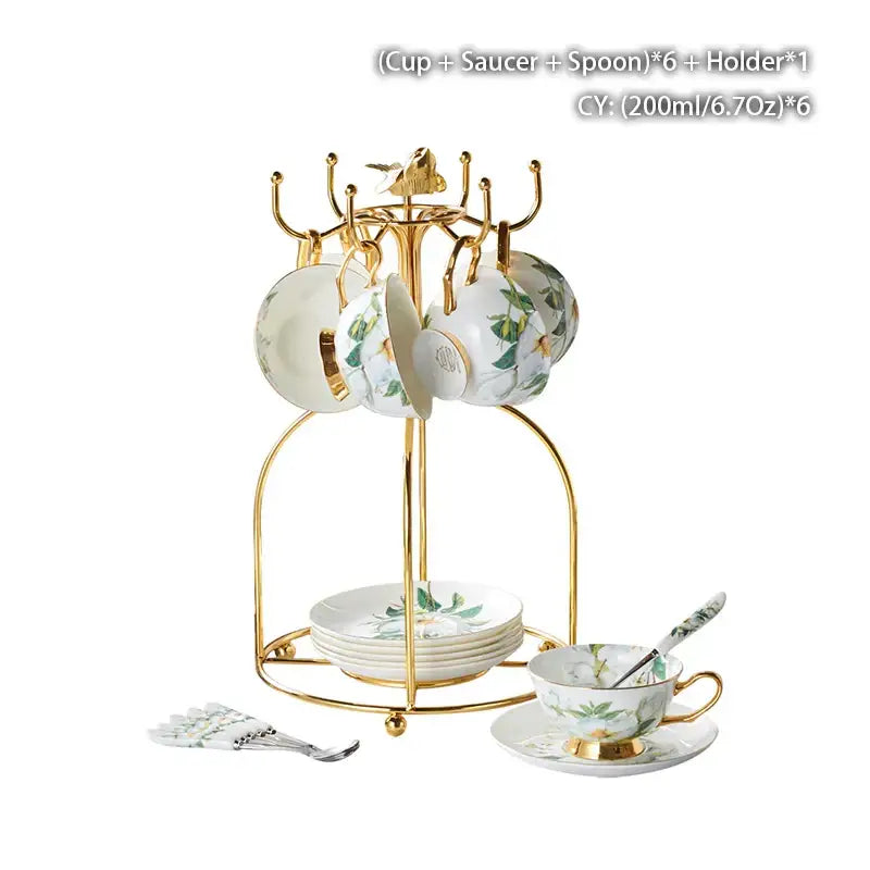 Gold-toned metal cup rack holding six white porcelain decorbites camellia bone china teacups with green leaves and gold rims