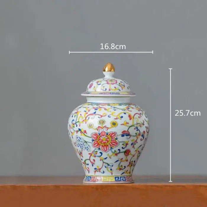 Floral white enamelled porcelain tea caddy ginger jar with gold-tipped lid and vibrant floral vine patterns